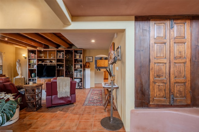 tiled living room with beamed ceiling