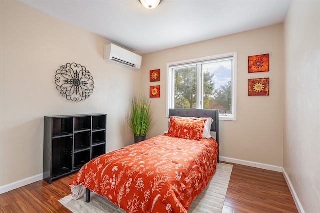 bedroom featuring a wall mounted AC and hardwood / wood-style flooring