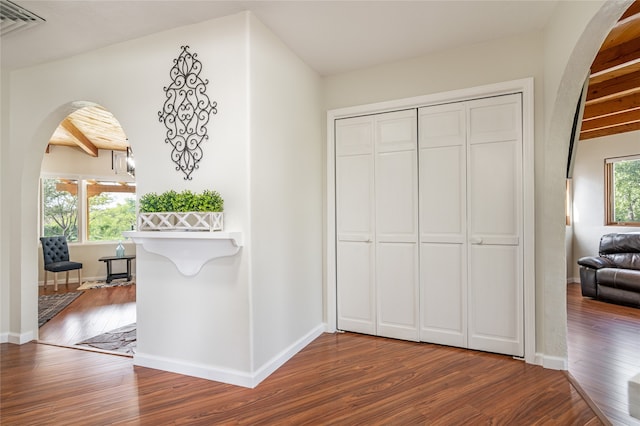 hall featuring beam ceiling and hardwood / wood-style flooring