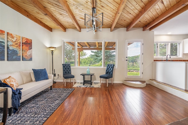 living room featuring beamed ceiling, hardwood / wood-style floors, wood ceiling, and an inviting chandelier