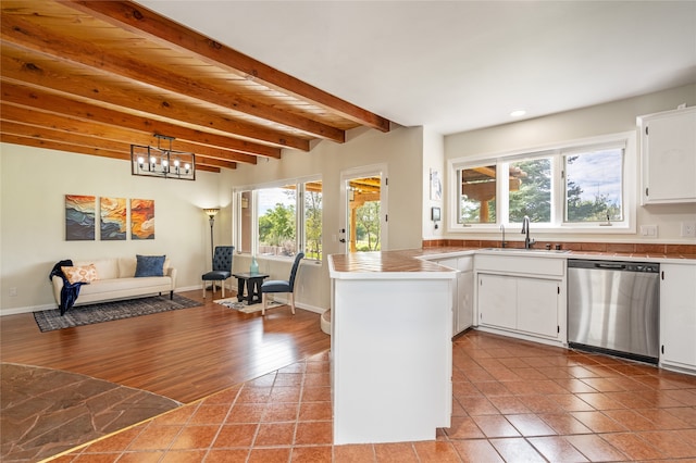 kitchen with dishwasher, light wood-type flooring, sink, white cabinetry, and beam ceiling