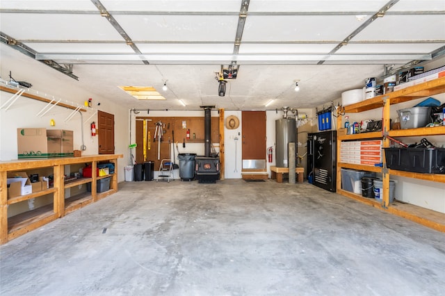 garage featuring water heater and a garage door opener