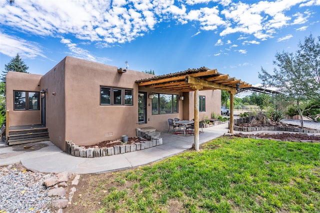 back of property with a patio, a pergola, and a yard