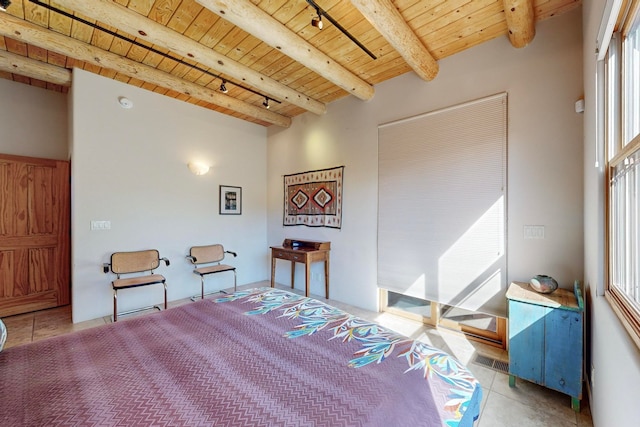 bedroom with multiple windows, beamed ceiling, wood ceiling, and light tile patterned floors