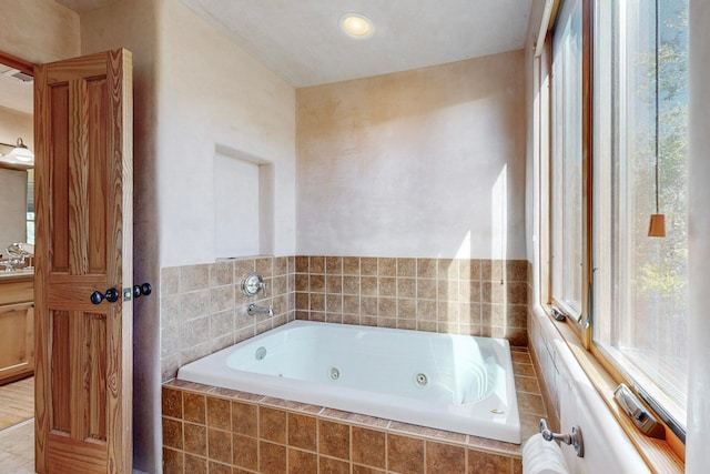 bathroom with tiled bath