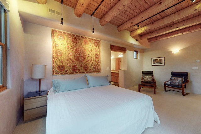 carpeted bedroom featuring beamed ceiling, wooden ceiling, and connected bathroom