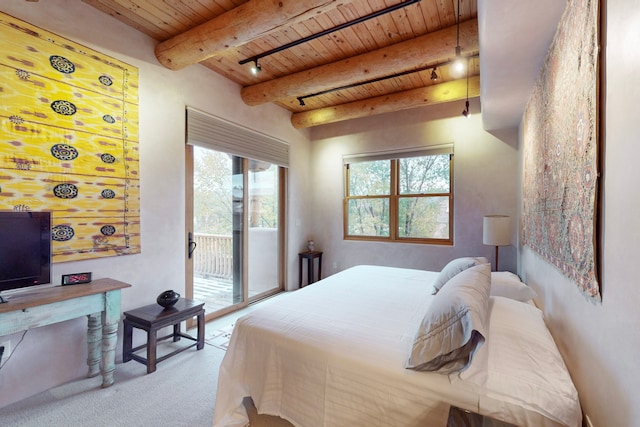 carpeted bedroom with beamed ceiling, wooden ceiling, and access to outside