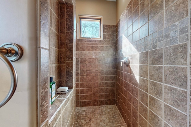 bathroom with a tile shower