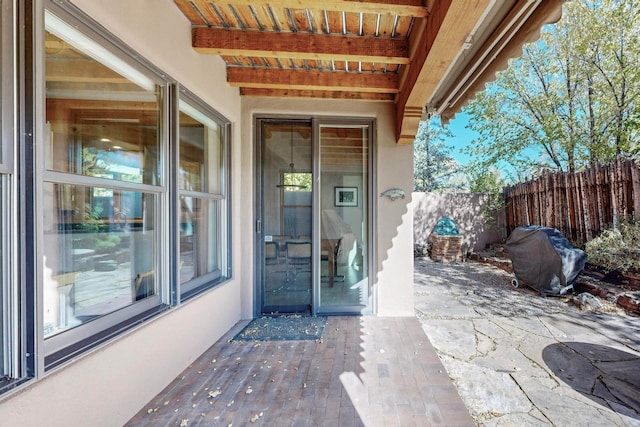 entrance to property featuring a patio