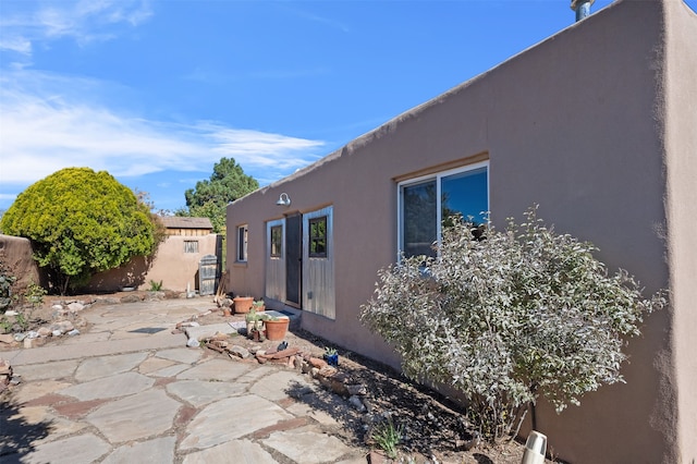 view of side of home with a patio