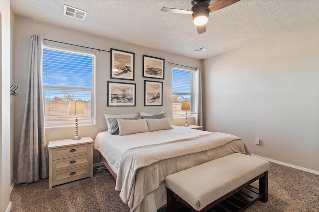 carpeted bedroom featuring a textured ceiling and ceiling fan