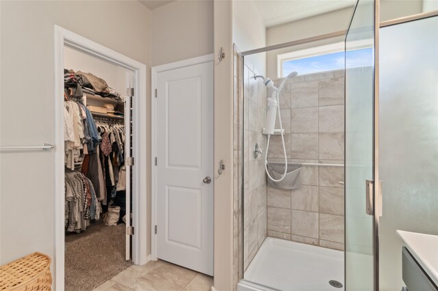 bathroom with a shower with door and vanity