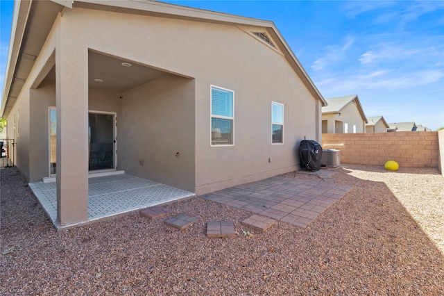 back of house featuring central AC and a patio