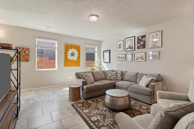 tiled living room featuring a textured ceiling