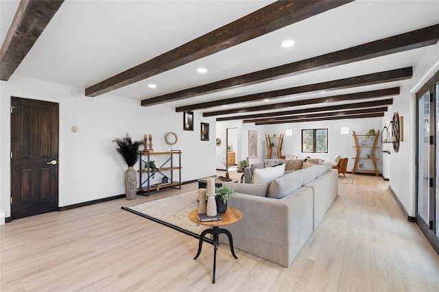 living room with beam ceiling and light wood-type flooring