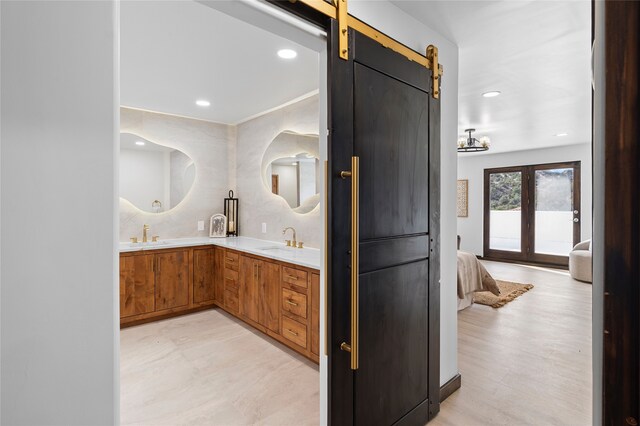 bathroom with vanity, french doors, and tasteful backsplash