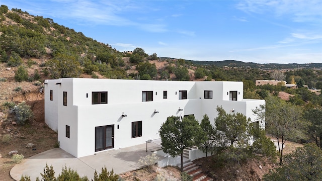 exterior space with a patio and a mountain view