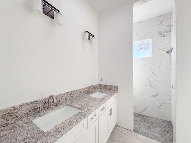 bathroom featuring vanity and a tile shower