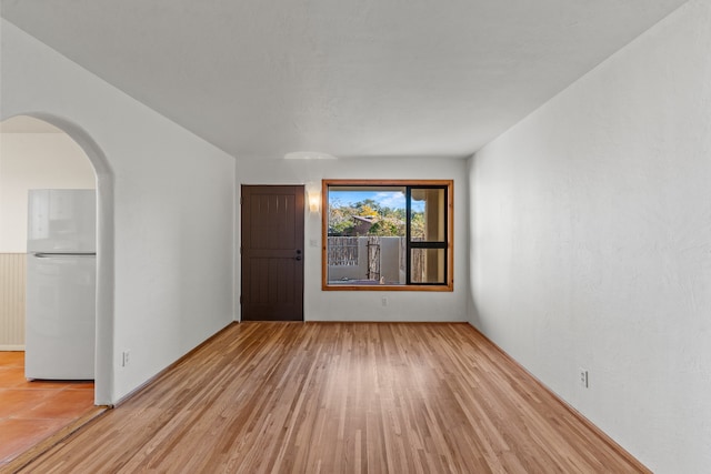 spare room featuring light hardwood / wood-style floors