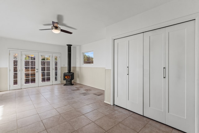 unfurnished bedroom with ceiling fan, french doors, and light tile patterned floors