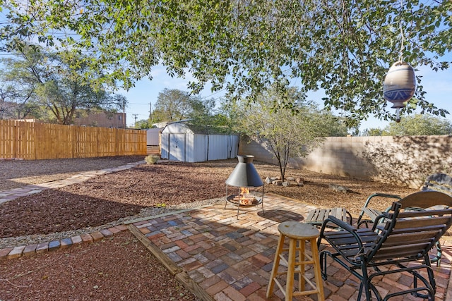 view of patio featuring a storage shed