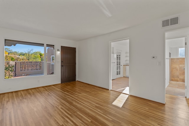 empty room with light hardwood / wood-style flooring