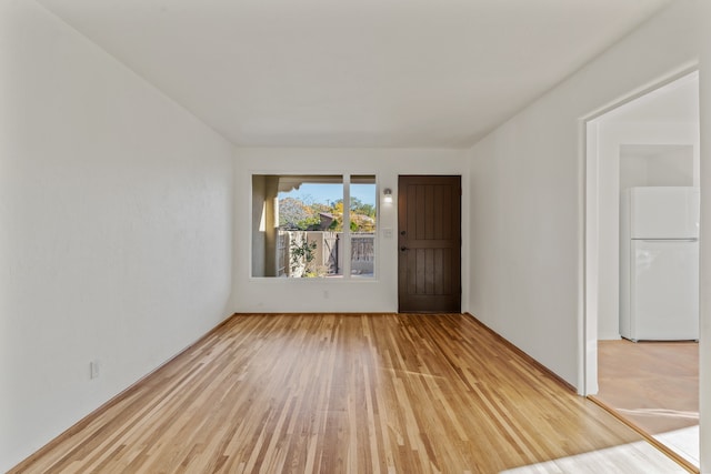 spare room with wood-type flooring