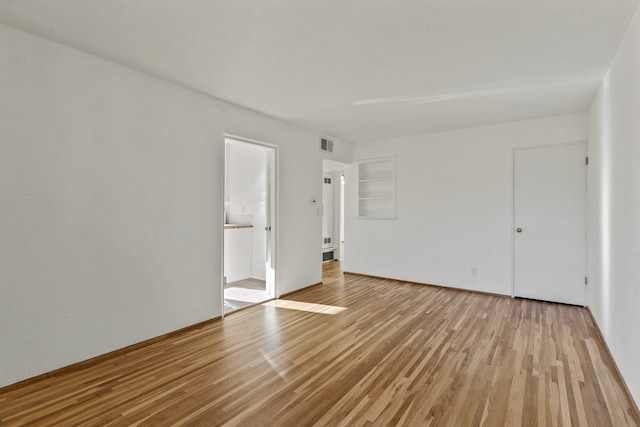 unfurnished room with light wood-type flooring