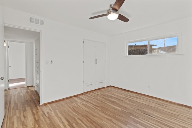 unfurnished bedroom with ceiling fan, a closet, and light wood-type flooring