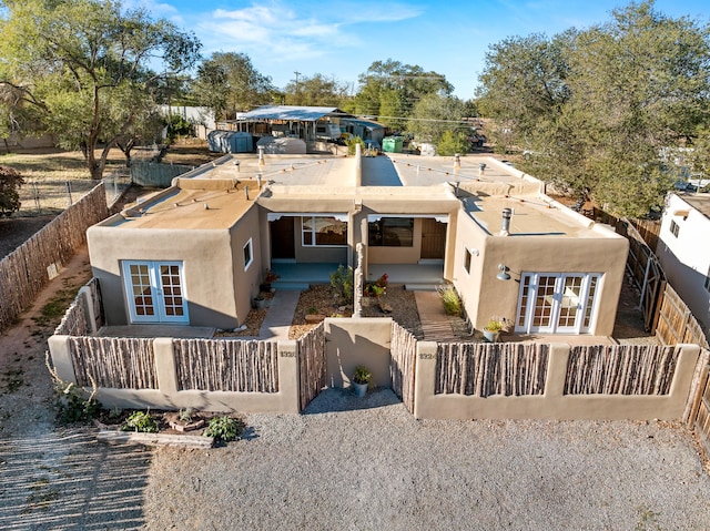 rear view of property featuring french doors