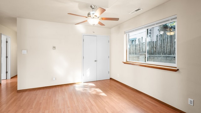 unfurnished bedroom featuring ceiling fan, a closet, and light hardwood / wood-style floors