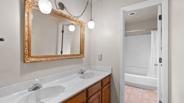 bathroom with vanity and shower / tub combo