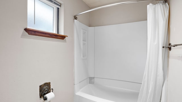 bathroom featuring shower / bathtub combination with curtain