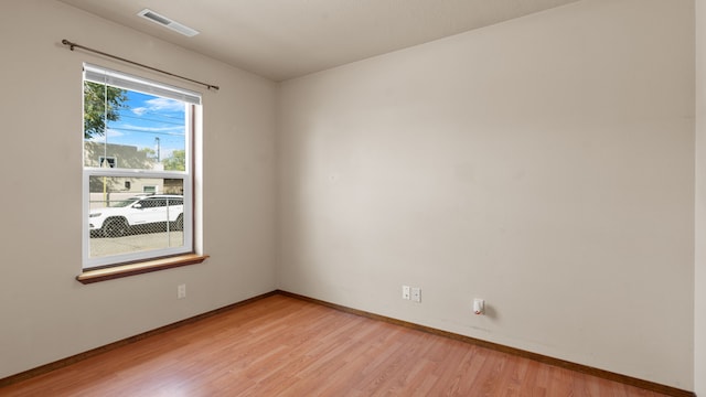 unfurnished room with light hardwood / wood-style floors