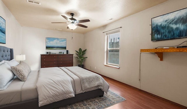 bedroom with ceiling fan and light wood-type flooring