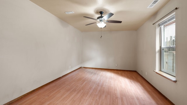 empty room with light hardwood / wood-style floors and ceiling fan