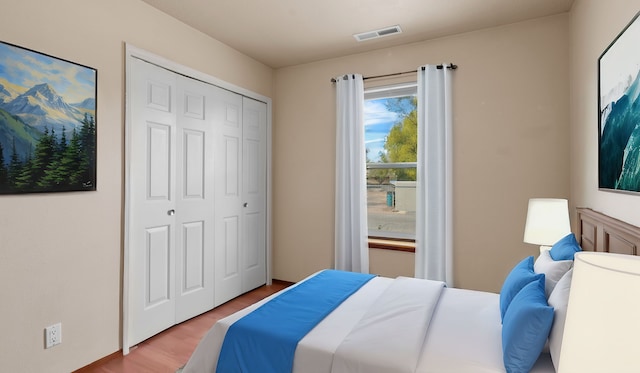 bedroom with light wood-type flooring and a closet