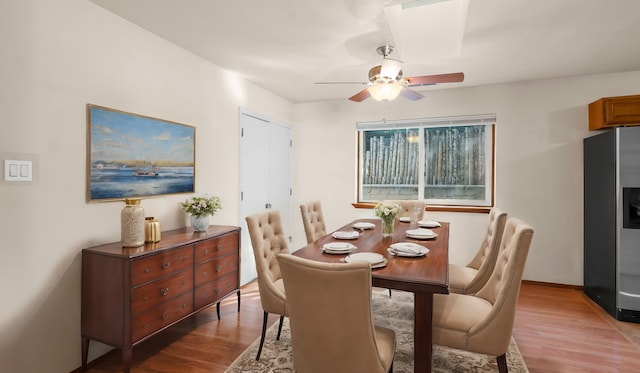 dining room with wood-type flooring and ceiling fan