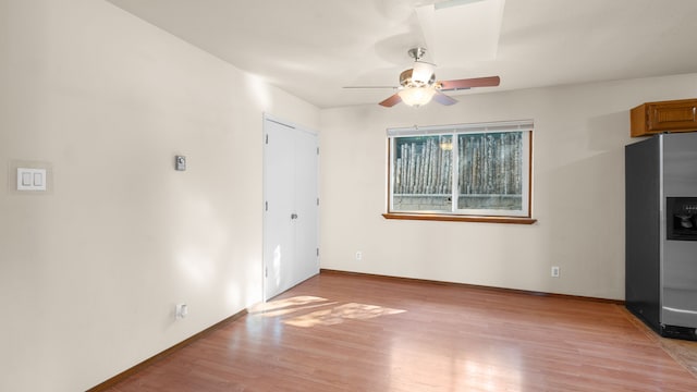 unfurnished living room featuring ceiling fan and light hardwood / wood-style floors