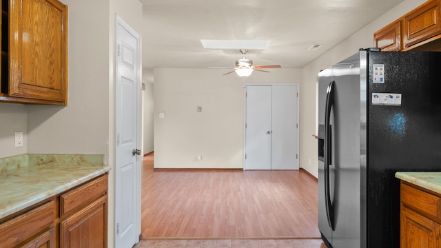 kitchen with ceiling fan, stainless steel fridge with ice dispenser, and light hardwood / wood-style flooring