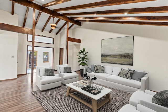 living room featuring wood-type flooring, high vaulted ceiling, and beam ceiling