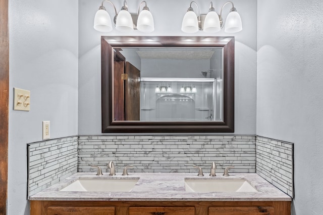 bathroom featuring tasteful backsplash, vanity, and a shower with shower door