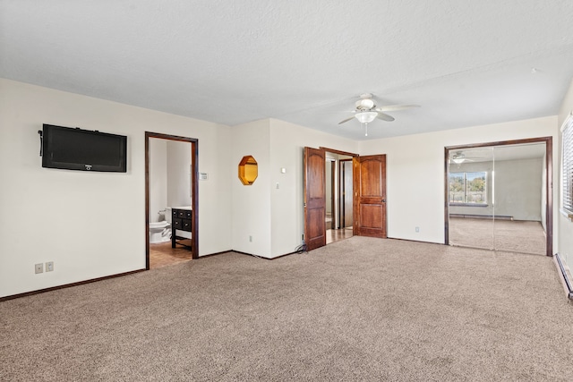 unfurnished bedroom with light carpet, ensuite bathroom, a textured ceiling, ceiling fan, and a baseboard radiator