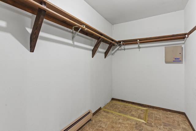 walk in closet featuring a baseboard heating unit