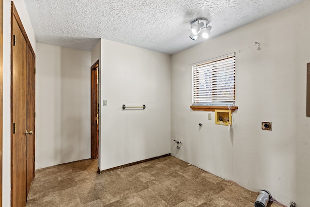 laundry room with electric dryer hookup, gas dryer hookup, a textured ceiling, and hookup for a washing machine