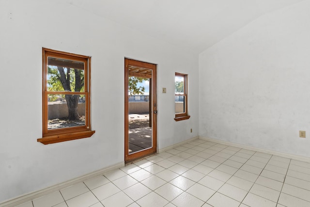 empty room with vaulted ceiling and plenty of natural light