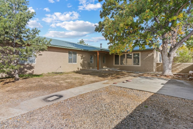 ranch-style home with a patio area