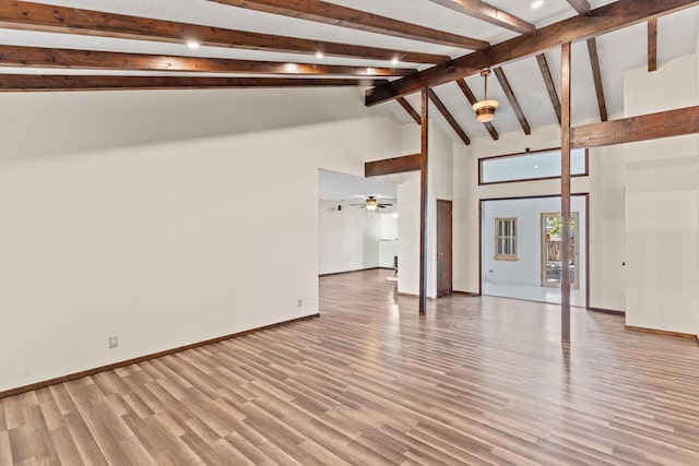 spare room featuring beamed ceiling, ceiling fan, high vaulted ceiling, and light hardwood / wood-style flooring