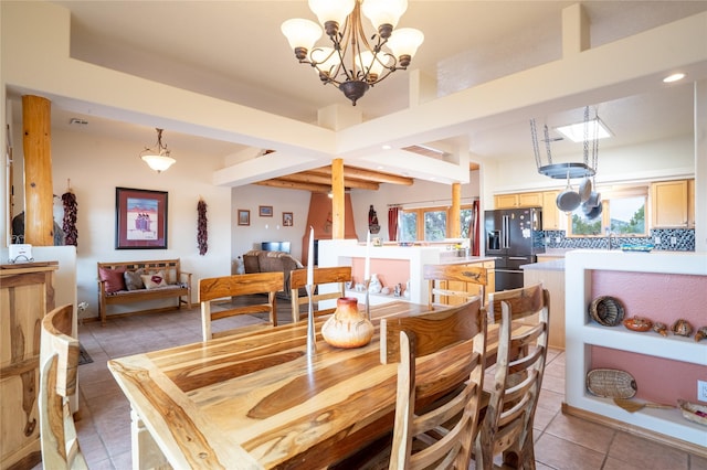 dining area featuring tile patterned flooring and an inviting chandelier