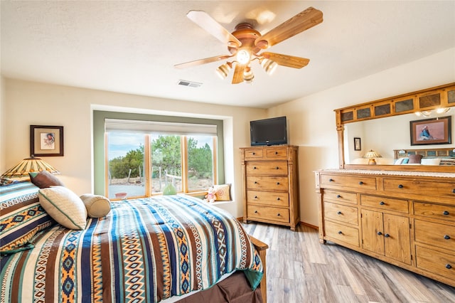 bedroom featuring ceiling fan and light wood-type flooring